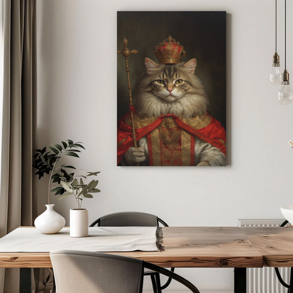 A majestic canvas portrait features a regal cat dressed as a king. The cat wears an ornate gold and red robe with intricate patterns and a luxurious red cape draped over its shoulders. On its head rests an elaborate golden crown adorned with jewels, and in one paw, the cat holds a royal scepter topped with a decorative cross. The cat's confident gaze and proud posture exude authority and nobility. The dark, softly lit background enhances the grandeur of the royal theme. Below the portrait, a wooden dining t